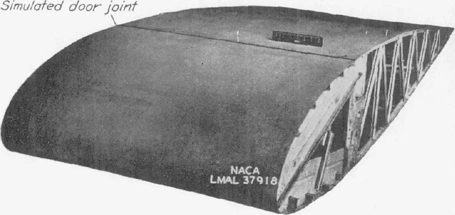 Photograph of a wooden NACA 23016 wing model with a simulated door joint across its upper surface